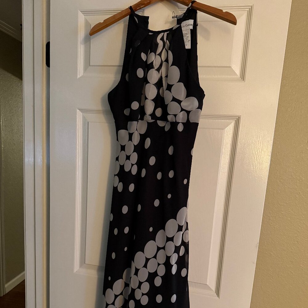 Sleeveless cocktail dress with hankerchief hem.